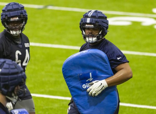 Bears offensive tackle Darnell Wright, right, practices during training camp Wednesday in the Walter Payton Center at Halas Hall.